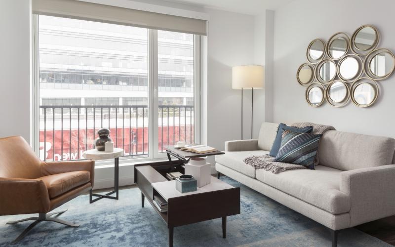 a living room with a couch, coffee table and chair