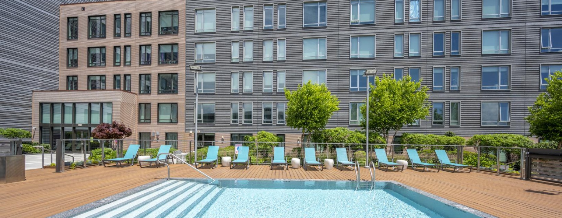 a swimming pool with lounge chairs