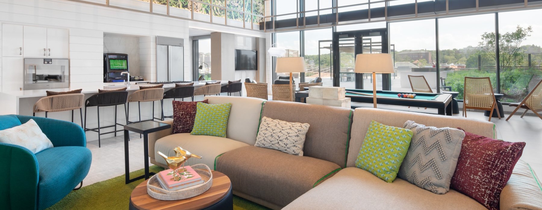 a lounge with a couch, tables and chairs