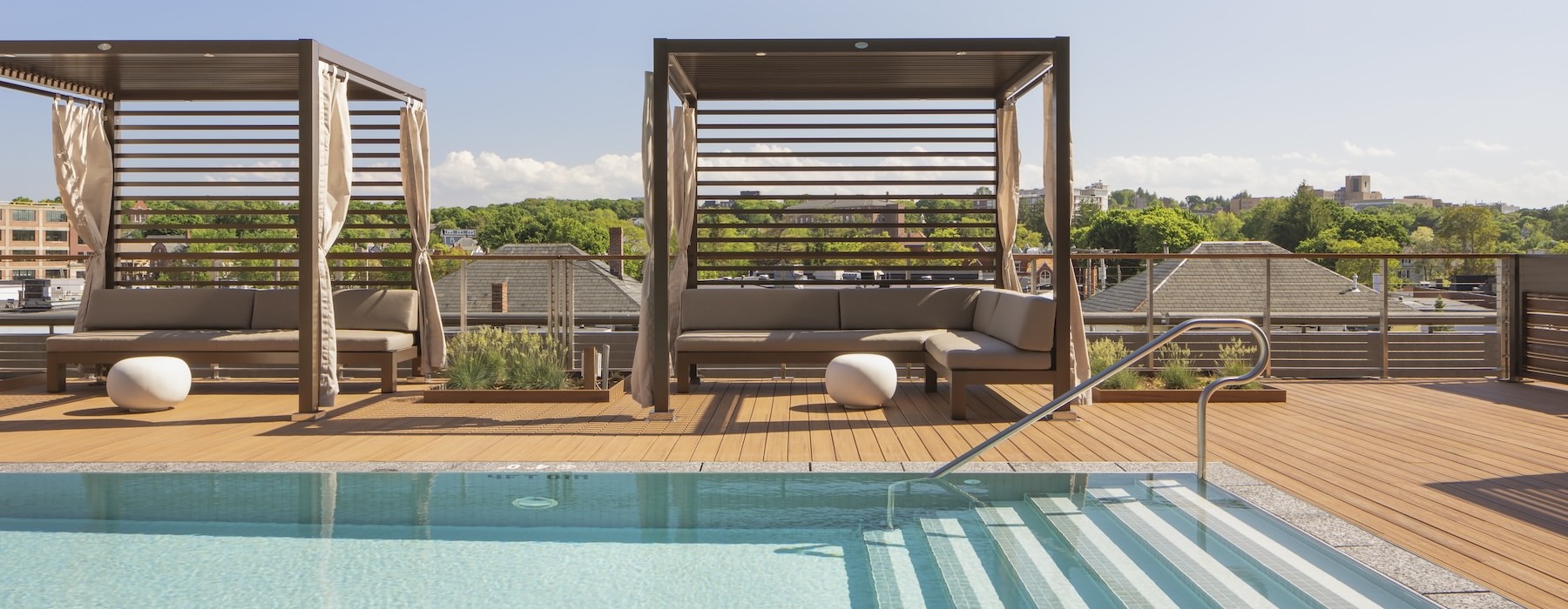a swimming pool with poolside lounge cabanas