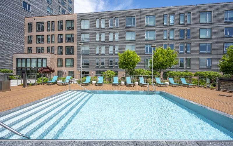 a swimming pool with lounge chairs